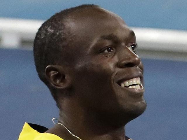 Usain Bolt of Jamaica poses next to the electronic result board after winning the gold medal in the race.(Reuters)