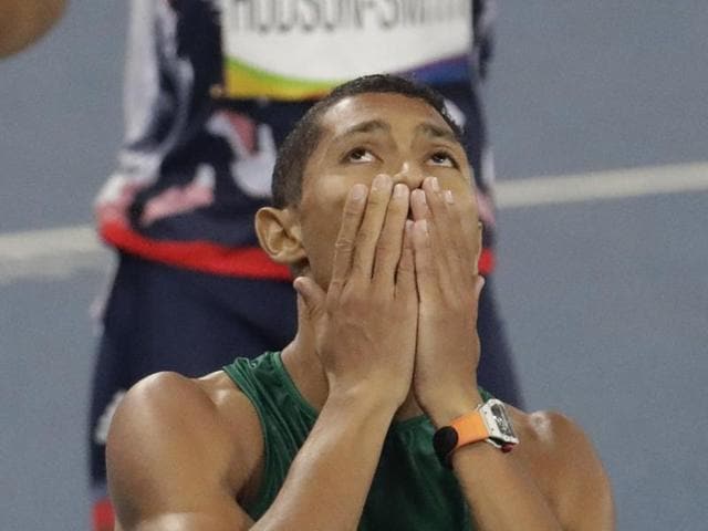 Van Niekerk celebrates after crossing the line. (AP Photo)