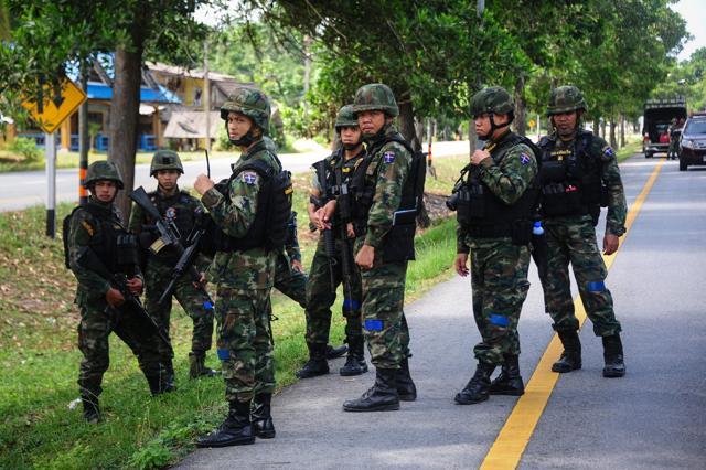 Thai soldiers watch as a forensic unit inspects the scene of an attack following two roadside bomb blasts at four separate locations by suspected separatist militants in the Bacho district of Thailand. (AFP Photo) Thai soldiers watch as a forensic unit inspects the scene of an attack following two roadside bomb blasts at four separate locations by suspected separatist militants in the Bacho district of Thailand. (AFP Photo)