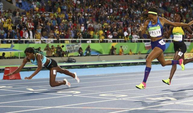 While most sprinters choose to leap forward at the end, neck forward, Miller took a different approach. While approaching the finish, she was neck and neck with Allyson Felix (right). Perhaps realising she may have to settle for silver, Miller launched herself forward. (REUTERS) While most sprinters choose to leap forward at the end, neck forward, Miller took a different approach. While approaching the finish, she was neck and neck with Allyson Felix (right). Perhaps realising she may have to settle for silver, Miller launched herself forward. (REUTERS)