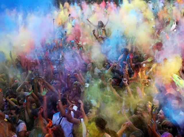 In Madrid every year, thousands dress up in white and come out to celebrate a festival of music, dance and colours. Shades of blue, green and yellow fill the air... (REUTERS) 