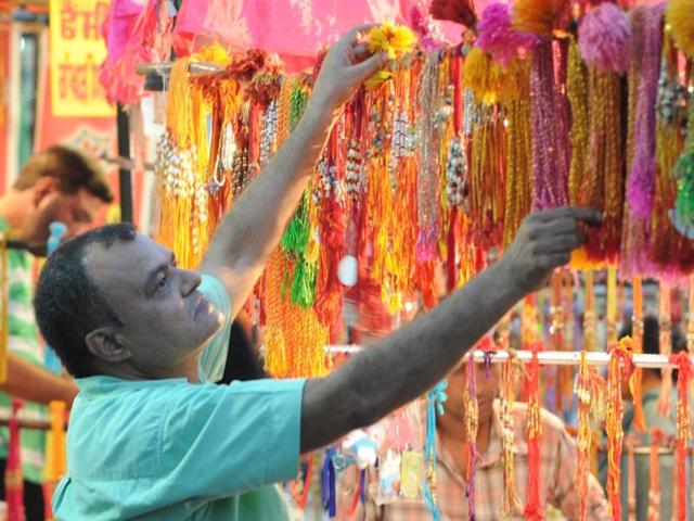 A shopkeeper decorating his shop ahead of the festival at Tripuri Town in Patiala on Wednesday. (Bharat Bhushan/HT Photo)