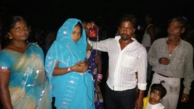 Parents wait outside the hospital as fire fighter douse the flames. (HT Photo) Parents wait outside the hospital as fire fighter douse the flames. (HT Photo)