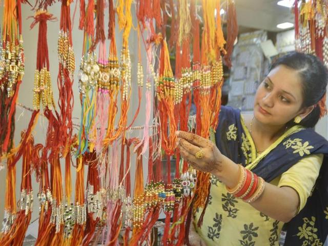 A newly-married woman buying rakhis ahead of the festival in Amritsar on Wednesday. (Sameer Sehgal/HT Photo)