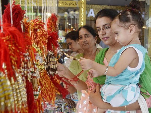 A little girl buying rakhis on the occasion in Amritsar on Wednesday. (Sameer Sehgal/HT Photo)