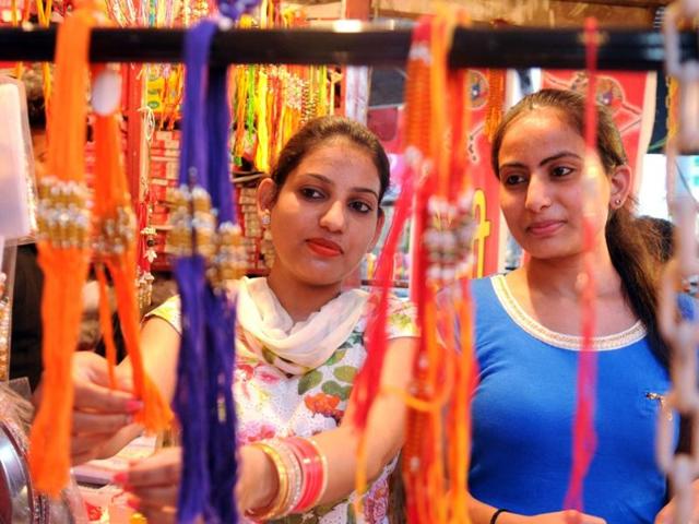 Newly-married women buy rakhis from a shop at Tripuri Town in Patiala on Wednesday. (Bharat Bhushan/HT Photo)
