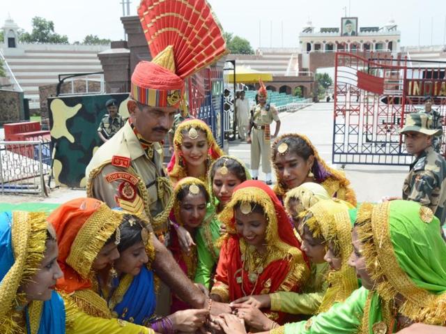 Girls tying rakhis on the wrist of BSF jawan in Amritsar on Wednesday. (Gurpreet Singh/HT Photo)
