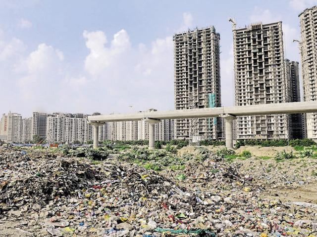 In the absence of a proper waste disposal mechanism, authorities in Noida and Greater Noida have been dumping solid waste in open spaces. (Sunil Ghosh/HT Photo) In the absence of a proper waste disposal mechanism, authorities in Noida and Greater Noida have been dumping solid waste in open spaces. (Sunil Ghosh/HT Photo)