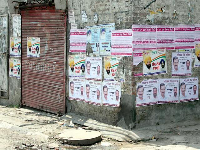 Unauthorised posters of political parties on walls at Bharat Nagar Chowk in Ludhiana.(JS Grewal/HT Photo)