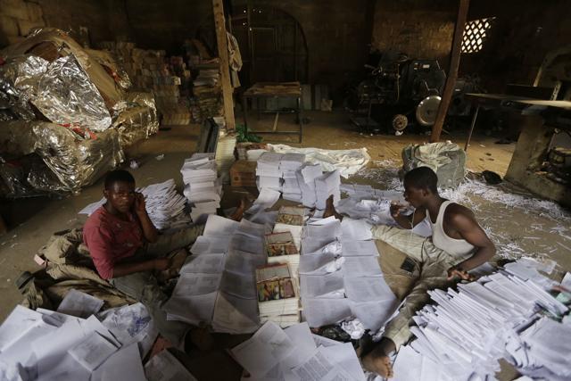 Young men sort out newly printed books in Kano, Nigeria. (AP) Young men sort out newly printed books in Kano, Nigeria. (AP)
