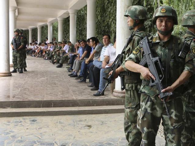 Paramilitary policemen stand guard during a ceremony to award those who the authorities say participated in "the crackdown of violence and terrorists activities" in Hotan, Xinjiang Uighur Autonomous Region August 3, 2014. (REUTERS) Paramilitary policemen stand guard during a ceremony to award those who the authorities say participated in "the crackdown of violence and terrorists activities" in Hotan, Xinjiang Uighur Autonomous Region August 3, 2014. (REUTERS)