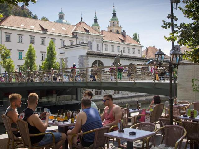 It is known for its tasty wines and food specialties such as Kranjska klobasa, a juicy pork sausage, or struklji, a traditional Slovene pastry with various fillings. In this Aug. 12, 2016 photo, a group of tourists drink beers in downtown Ljubljana. (AP) 