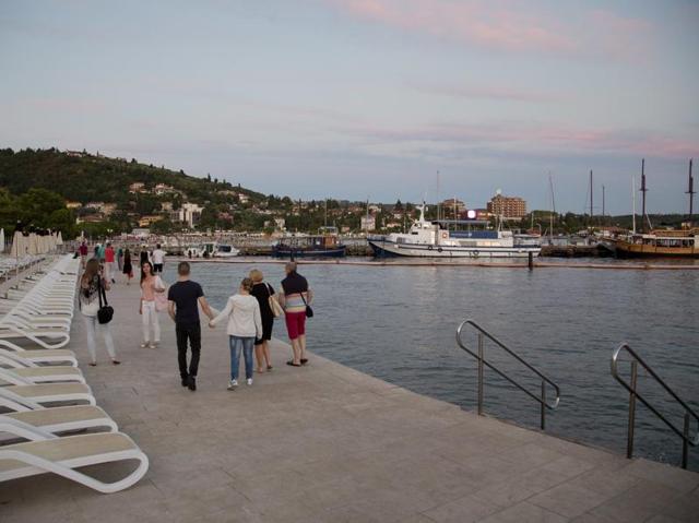 Slovenia is often confused with another small central European state, Slovakia. But ever since Donald Trump joined the presidential race in the US, the nation has come to limelight. In this Aug. 12, 2016 photo, tourists walk on the seafront in Portoroz. (AP) 