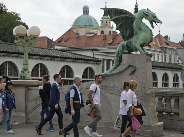 Donald Trump’s wife and potential first lady Melania Knauss belongs to Slovenia, her maiden name being Melanija Knavs.  In this Aug. 12, 2016 photo, tourists and residents walk by a statue of a dragon, a symbol of the city in Ljubljana. (AP) 