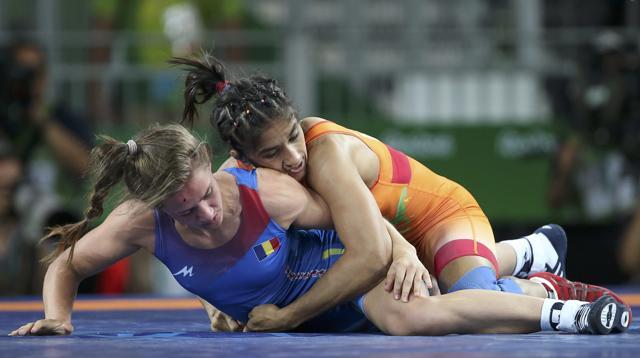 Vinesh Phogat tries to pin down Emilia Alina Vuc of Romania compete. (REUTERS) Vinesh Phogat tries to pin down Emilia Alina Vuc of Romania compete. (REUTERS)