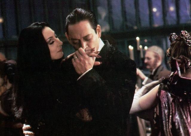 Angelica Huston and Raul Julia in The Addams Family. Angelica Huston and Raul Julia in The Addams Family.