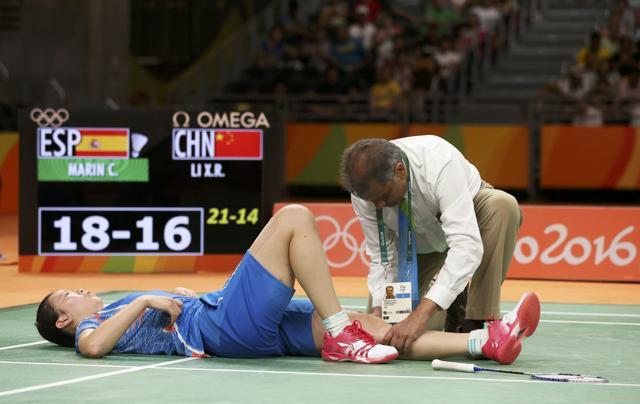 Li Xuerui has her injury tended to by medic Ashwinkumar Patel. (REUTERS) Li Xuerui has her injury tended to by medic Ashwinkumar Patel. (REUTERS)