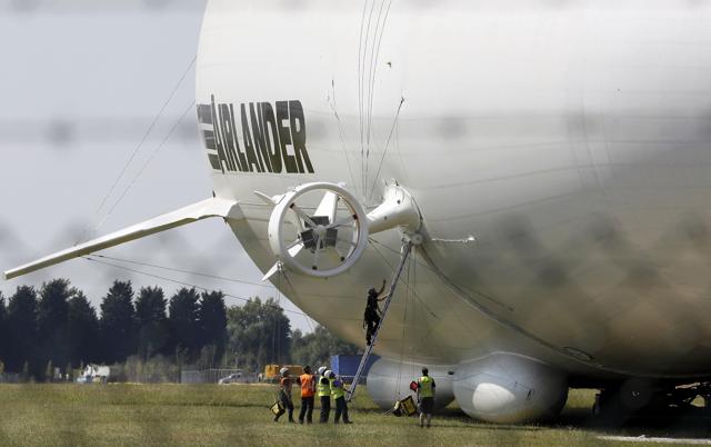 The Airlander 10 hybrid airship undergoes checks before its maiden flight at Cardington Airfield in Britain. (REUTERS) The Airlander 10 hybrid airship undergoes checks before its maiden flight at Cardington Airfield in Britain. (REUTERS)