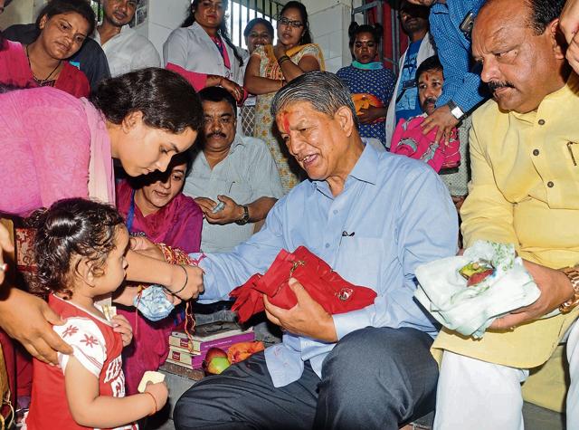 A woman ties a rakhi on Harish Rawat’s wrist at a Dehradun Nari Niketan on Thursday, just one of the many enagements the chief minister scheduled for the day. (Vinay Santosh Kumar / HT Photo) A woman ties a rakhi on Harish Rawat’s wrist at a Dehradun Nari Niketan on Thursday, just one of the many enagements the chief minister scheduled for the day. (Vinay Santosh Kumar / HT Photo)