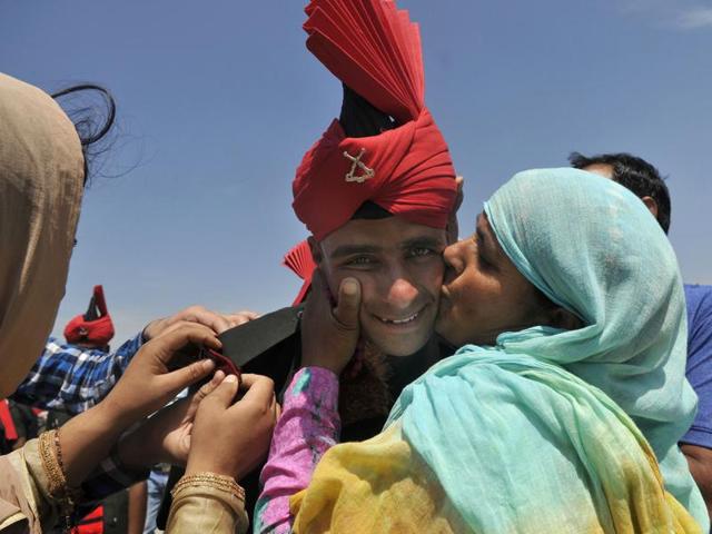 A mother kisses her son, celebrating his achievement after he graduates as an Indian army soldier. (Waseem Andrabi/HT Photo) A mother kisses her son, celebrating his achievement after he graduates as an Indian army soldier. (Waseem Andrabi/HT Photo)