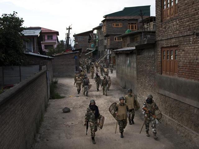 Paramilitary soldiers walk back towards their base camp after a day-long curfew in Srinagar. (AP) Paramilitary soldiers walk back towards their base camp after a day-long curfew in Srinagar. (AP)