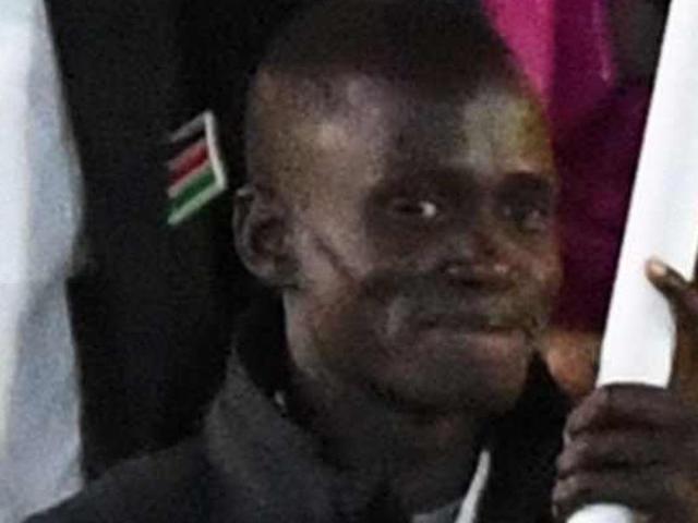 South Sudan's flag-bearer Guor Marial leads his delegation during the opening ceremony. 28 members of his family were killed during the Sudan civil war.(AFP Photo)