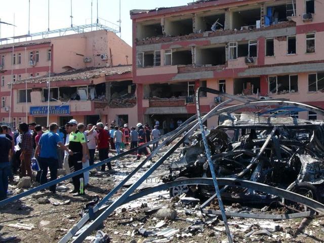 Turkish authorities search outside a damaged building after an explosion in Elazig, eastern Turkey, on Thursday, Aug. 18, 2016. Two car bombings targeted police stations in Turkey, killing a number of people and wounding hundreds, officials said Thursday.(AP)