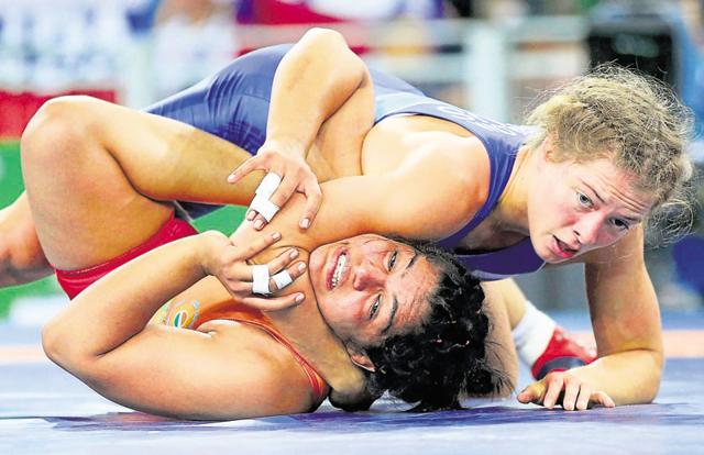 Vinesh was in tears lying on the mat, clutching her right leg. She was leading 1-0 in her quarterfinal bout against Sun Yanan of China when, while resisting an ankle tap, she injured her knee and conceded the bout. (REUTERS) Vinesh was in tears lying on the mat, clutching her right leg. She was leading 1-0 in her quarterfinal bout against Sun Yanan of China when, while resisting an ankle tap, she injured her knee and conceded the bout. (REUTERS)