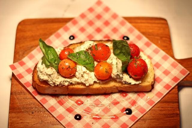 In the roasted tomato bruchetta, the cherry tomatoes scattered over thick mounds of ricotta and toasted ciabatta are an appetising match of tartness and creaminess. (Satyabrata Tripathy / HT Photo )