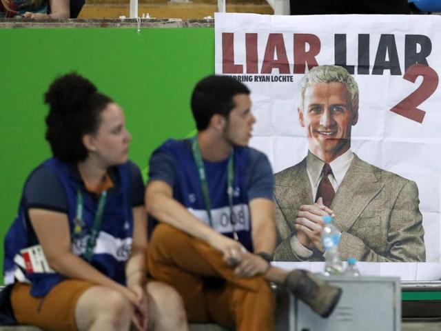 A poster showing a likeness of Ryan Lochte of USA is seen at the athletics stadium in Rio on Thursday.(REUTERS)