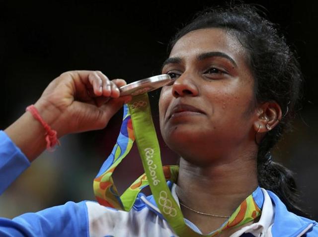 Silver medallist P.V. Sindhu (IND) of India poses with an Indian national flag.(REUTERS) Silver medallist P.V. Sindhu (IND) of India poses with an Indian national flag.(REUTERS)