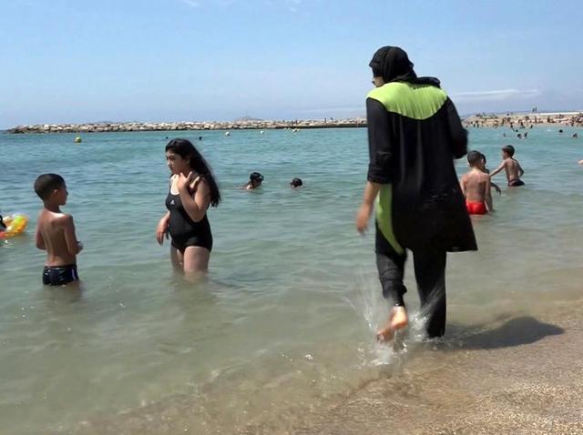In this file photo made from video, Nissrine Samali, 20, gets into the sea wearing traditional Islamic dress, in Marseille, southern France.(AP)
