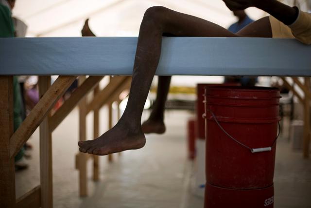 Boys lie on cholera beds, cots with a hole cut into the center and a bucket underneath, in a cholera clinic in Port-au-Prince, Haiti, in November, 2010. (REUTERS FILE) Boys lie on cholera beds, cots with a hole cut into the center and a bucket underneath, in a cholera clinic in Port-au-Prince, Haiti, in November, 2010. (REUTERS FILE)