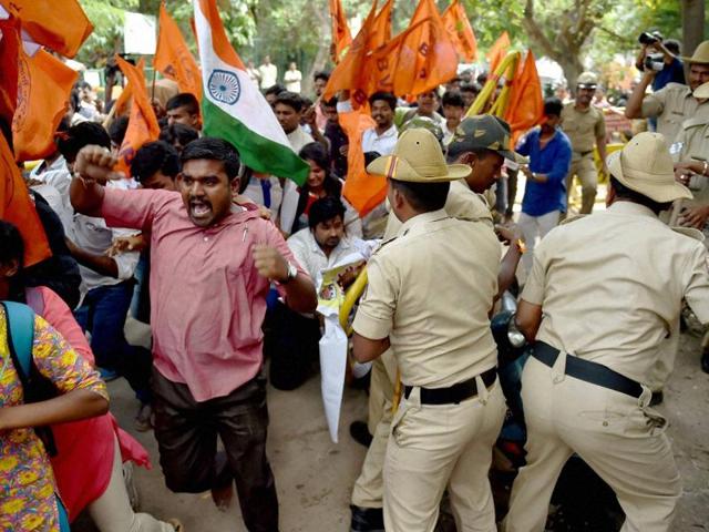 Police stop ABVP activists who were trying to enter the Amnesty International India office during a protest against the NGO in Bengaluru. (PTI Photo) Police stop ABVP activists who were trying to enter the Amnesty International India office during a protest against the NGO in Bengaluru. (PTI Photo)