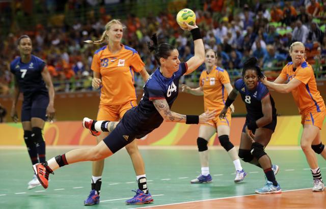 France's Alexandra Lacrabere (centre) scores a goal during the women's semifinal handball match against the Netherlands in Rio de Janeiro on Thursday. (AP) France's Alexandra Lacrabere (centre) scores a goal during the women's semifinal handball match against the Netherlands in Rio de Janeiro on Thursday. (AP)