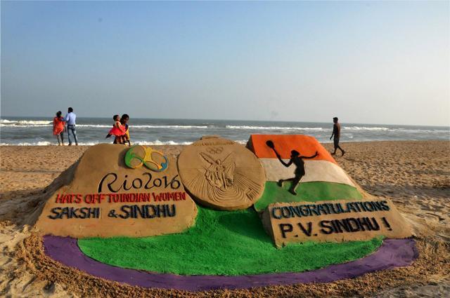 Sand artist Manas Sahoo creates a sand sculpture with message to congratulate Indian sportswomen participating in Rio Olympics, in Puri. (PTI Photo) Sand artist Manas Sahoo creates a sand sculpture with message to congratulate Indian sportswomen participating in Rio Olympics, in Puri. (PTI Photo)