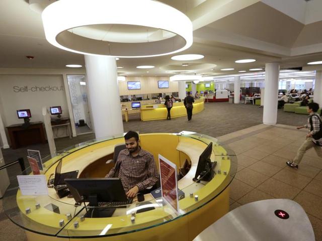 A Northeastern University graduate student  at the entrance to the Snell Library on the Northeastern University campus in Boston. College libraries are being re-imagined as hubs of university life where students can talk in group study rooms, or use high-tech gadgets as study aids.  (AP) 