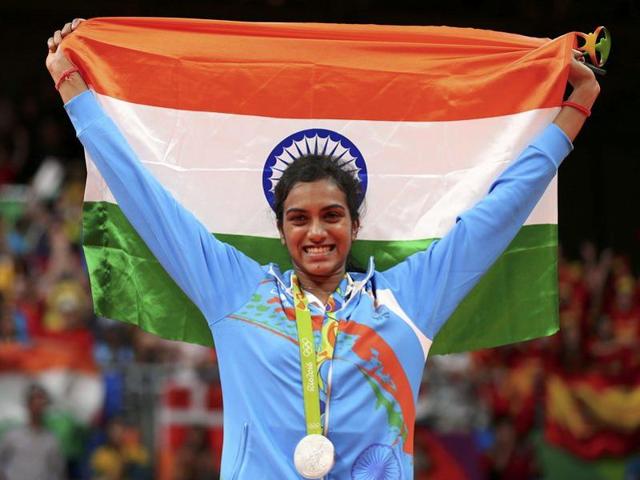 Badminton women’s singles silver medallist PV Sindhu poses with the tricolour on the podium. (Marcelo del Pozo/REUTERS)