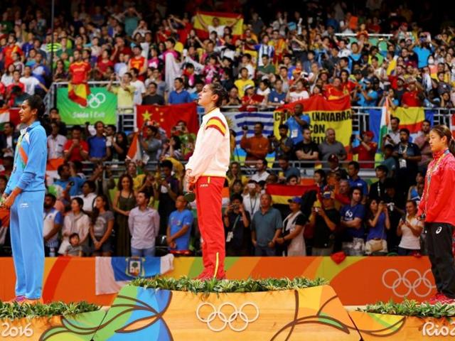 Gold medallist Carolina Marin (center) of Spain, silver medallist PV Sindhu (left) of India and bronze medallist Nozomi Okuhara of Japan stand on the podium. (Mercelo del pozo/Reuters)
