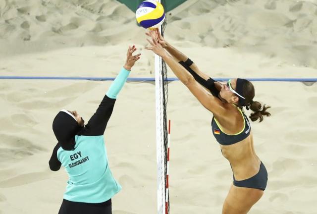 Doaa Elghobashy of Egypt and Kira Walkenhorst of Germany compete in beach volleyball. (Reuters ) Doaa Elghobashy of Egypt and Kira Walkenhorst of Germany compete in beach volleyball. (Reuters )