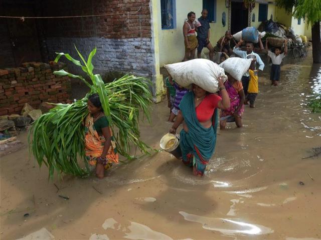 People relocate after their houses got submerged in UP’s Mirzapur on Friday. (PTI) People relocate after their houses got submerged in UP’s Mirzapur on Friday. (PTI)