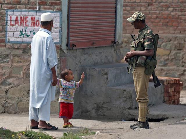 A boy gestures at a member of the security forces in Srinagar as the city remains under curfew following weeks of violence in Kashmir. (Reuters) A boy gestures at a member of the security forces in Srinagar as the city remains under curfew following weeks of violence in Kashmir. (Reuters)