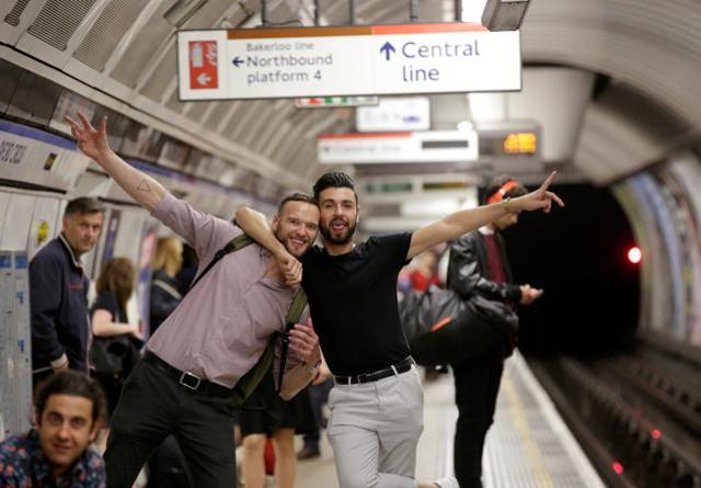 Passengers pose for a photograph as they wait for the Night Tube service at Oxford Circus on the London underground system on Saturday. (Reuters) Passengers pose for a photograph as they wait for the Night Tube service at Oxford Circus on the London underground system on Saturday. (Reuters)