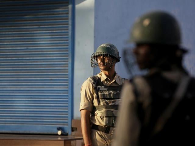 A Kashmiri protester runs for cover as a tear gas shell explodes near him in Srinagar.(AP)