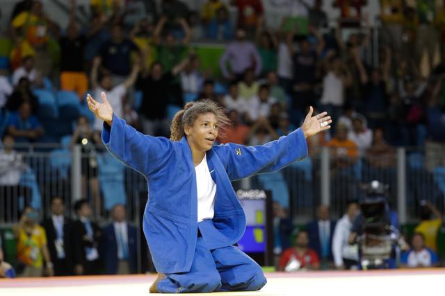 Brazil's Rafaela Silva celebrates after winning the gold medal in the women's 57kg judo competition. (AP) Brazil's Rafaela Silva celebrates after winning the gold medal in the women's 57kg judo competition. (AP)