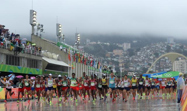 Athletes on the starting stretch of the men's marathon at the 2016 Summer Olympics in Rio de Janeiro on Sunday. (AP) Athletes on the starting stretch of the men's marathon at the 2016 Summer Olympics in Rio de Janeiro on Sunday. (AP)