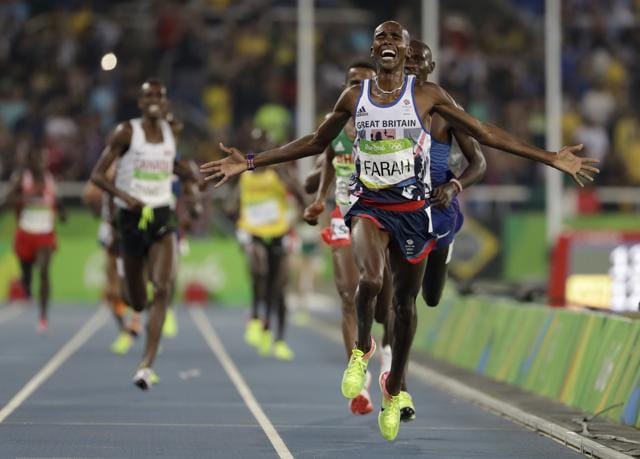 Arms outstretched, Mo Farah crosses the finish line to win gold in the 5,000m. (AP) Arms outstretched, Mo Farah crosses the finish line to win gold in the 5,000m. (AP)