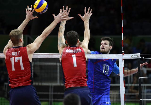 Russia's Egor Kliuka (right) tries to get the ball past United States' Maxwell Holt, left, and Matthew Anderson during a men's bronze medal volleyball match at the 2016 Summer Olympics in Rio de Janeiro on Sunday. (AP) Russia's Egor Kliuka (right) tries to get the ball past United States' Maxwell Holt, left, and Matthew Anderson during a men's bronze medal volleyball match at the 2016 Summer Olympics in Rio de Janeiro on Sunday. (AP)