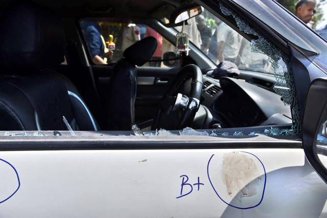 A damaged window of the car in which the criminals involved in a shootout with the Delhi Police were travelling. (Arun Sharma/HT Photo) A damaged window of the car in which the criminals involved in a shootout with the Delhi Police were travelling. (Arun Sharma/HT Photo)