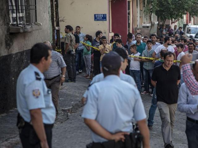 People watch the explosion scene in Gaziantep in southeastern Turkey near the Syrian border following a late night attack on a wedding party that left at least 51 dead. (AFP Photo) People watch the explosion scene in Gaziantep in southeastern Turkey near the Syrian border following a late night attack on a wedding party that left at least 51 dead. (AFP Photo)